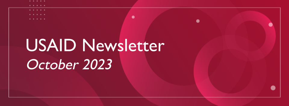 White text reading "USAID Newsletter October 2023" on a red gradient background. 