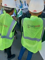 Students in Gharyan assemble USAID provided recycling containers for their school.