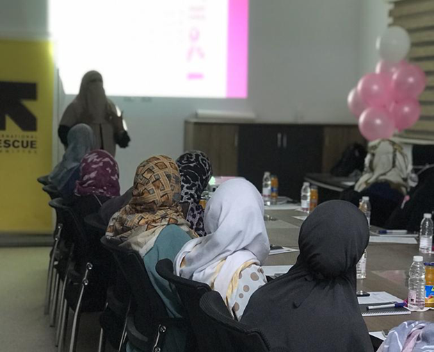 Women and girls attend an awareness session on breast cancer organized by the Tawergha Youth Club.