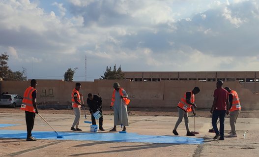 Youth volunteering to refurbish  a community center  in the city of Tawergha as part of their Peace Project.  