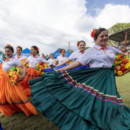Honduran youth in colorful outfits performing a folkloric dance.