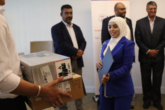 Recent graduates of auditor training receive new equipment from USAID.