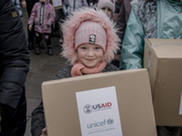 Child receiving winter clothes by UNICEF, financed by USAID.