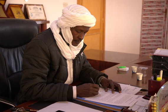 Mohamed Othman Adam, Acting Chair of the Murzuq Steering Committee signs and agreement with USAID's Libya Economic Accelration Program.