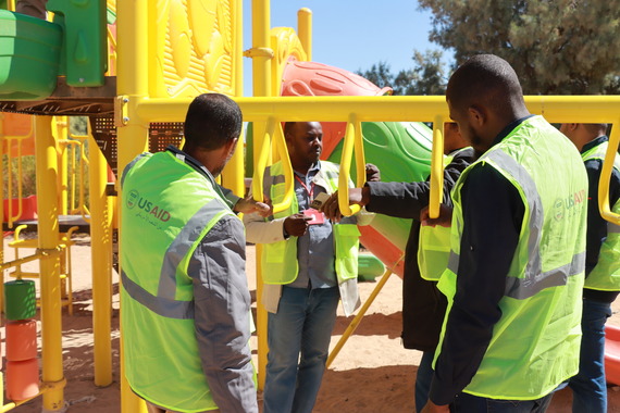 Vollunteers visited Albawanees' new playground to see how to properly install the playground equipment.