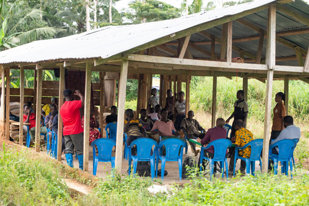 An impact evaluation team conducts a scoping visit with cocoa farmers in Ghana. 