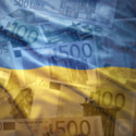 Ukraine flag overtop Ukrainian currency