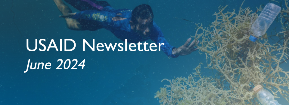 A man dives for plastic bottles underwater. White text reads "USAID Newsletter June 2024"