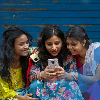 Three women looking at a cell phone