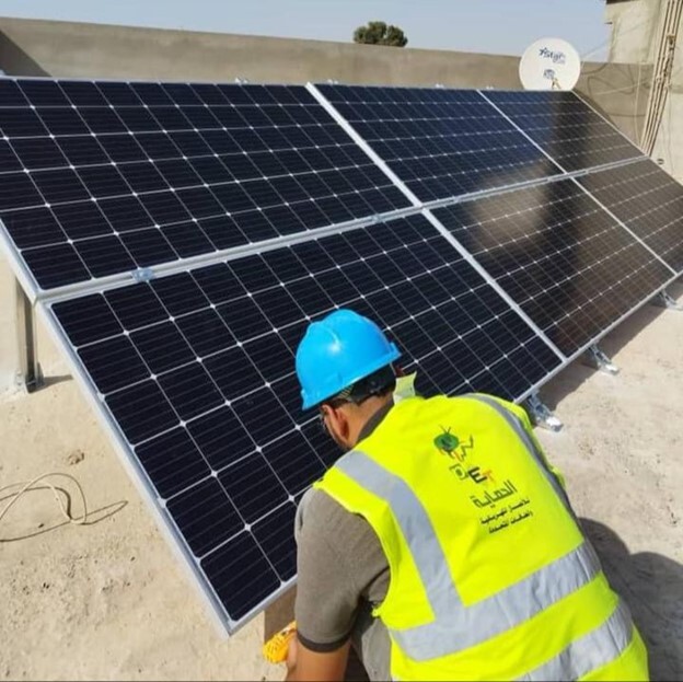 Mohamed El Amin installing solar panels in southern Libya.