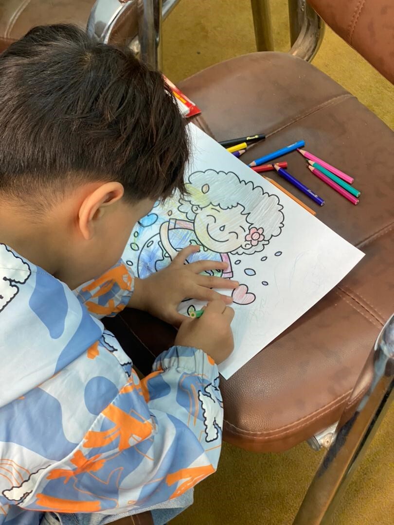 A young boy learns about the impact of climate change in the “Save the Earth for the Children” initiative. 