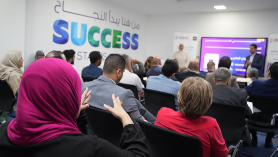 Investors ask questions of business owners at demo day in Tripoli.