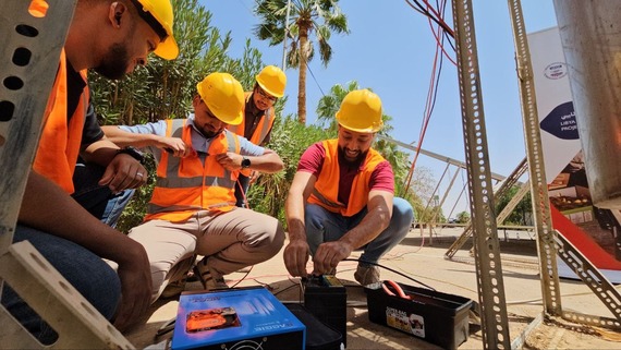 Technicians learn about battery installation in the ten day training.