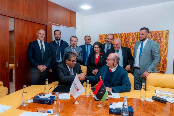 USAID DCR Alicia Contreras-Donello watches the signing of the new MOU with the Ministry of Planning f