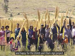 People in the high Andean valley posing with the quinoa harvest in Peru