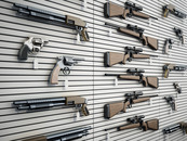 Guns hanging on a wall in a gun shop