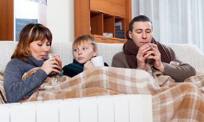 sick family bundled up on couch