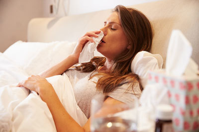 woman sick in bed with flu