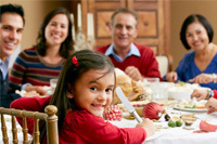 family sitting at table for holiday meal