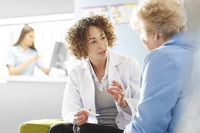 female doctor talking with adult patient