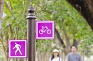 Street sign with symbols for a bicycle and a pedestrian.