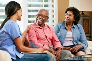 A community health worker meets with a couple in their home. 