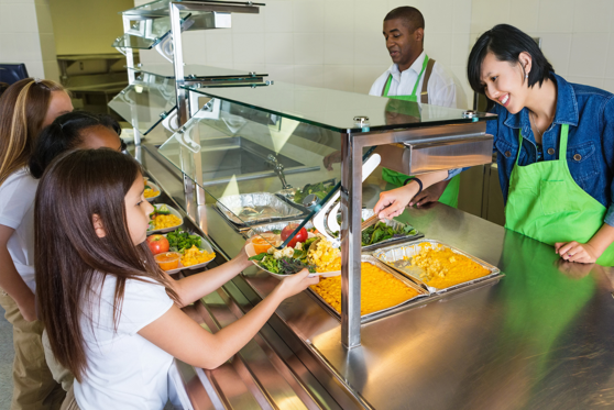 Woman serving food to children