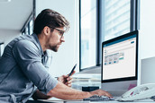 Man sitting at desk and computer