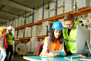 Female and male coworkers in construction vests