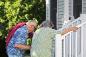 Two elderly persons climbing stairs