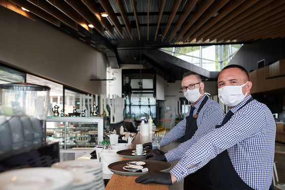 Two restaurant workers wearing masks
