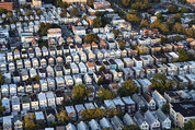 An aerial view of houses and buildings in a city.