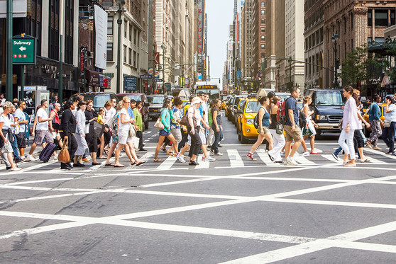 People crossing a busy street in New York City