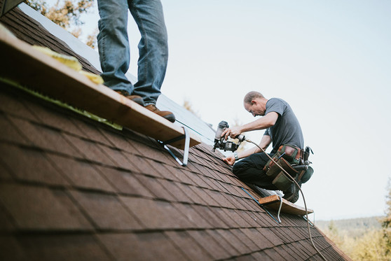 People working on the roof of a house