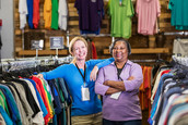 Two female staffers working at a clothing store