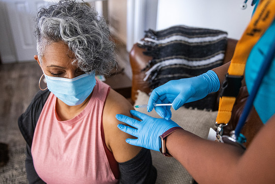 A woman receives a vaccination.