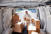 A driver for a delivery service gets ready to deliver some packages.