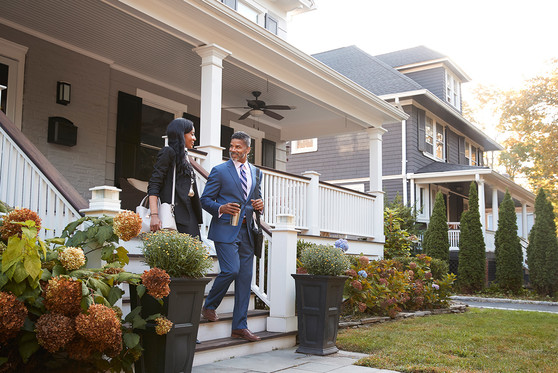 A couple leaves their house in the suburbs to commute to work.