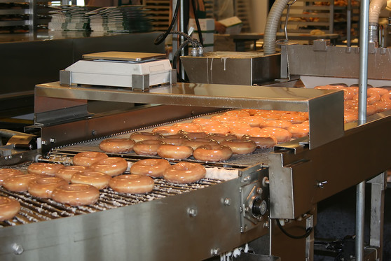 Doughnuts being mass produced at a doughnut manufacturing plant