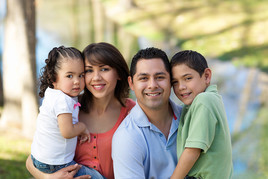 A loving and caring Hispanic family smiling at the camera