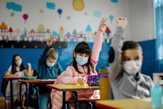 Children in a classroom setting wearing face masks