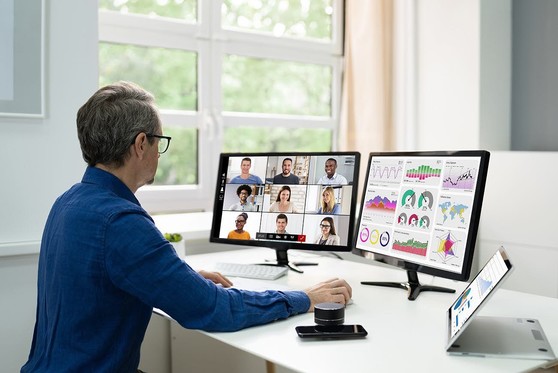 A man participates in a business meeting held virtually.