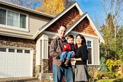 A family stands outside of their house.