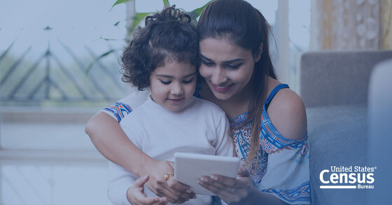 A woman and a child do an activity together on a tablet device.