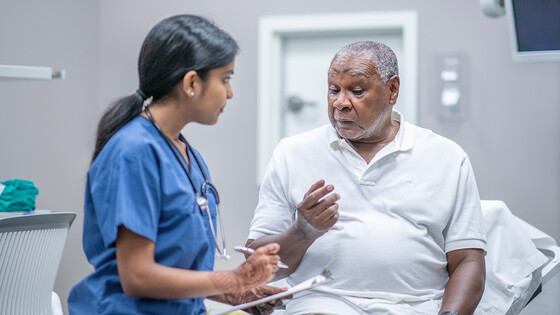 A nurse speaks with a patient about medical issues.