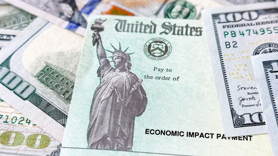 A U.S. Treasury-issued Economic Impact Payment sits in a pile of U.S. currency.