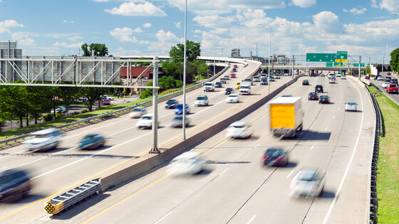 Traffic flows steadily along a U.S. highway in both directions.