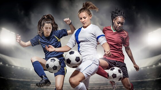 Three women playing soccer