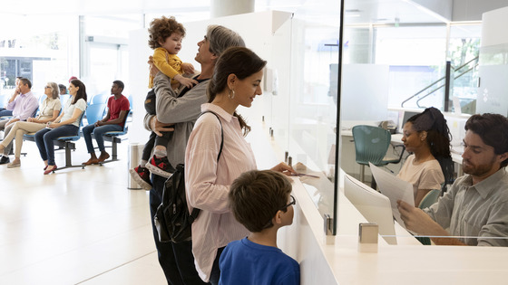 A family stands behind a service counter