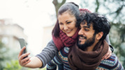 A Middle Eastern couple taking a selfie photo. 